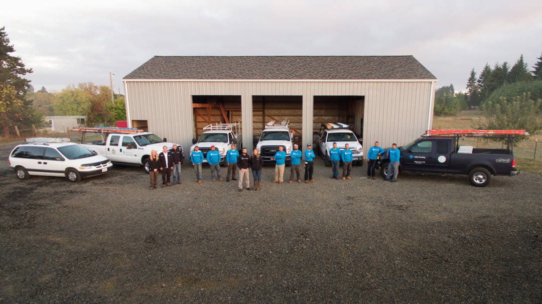 Owner and crew with vehicle fleet Valley Roofing Oregon Valley Roofing