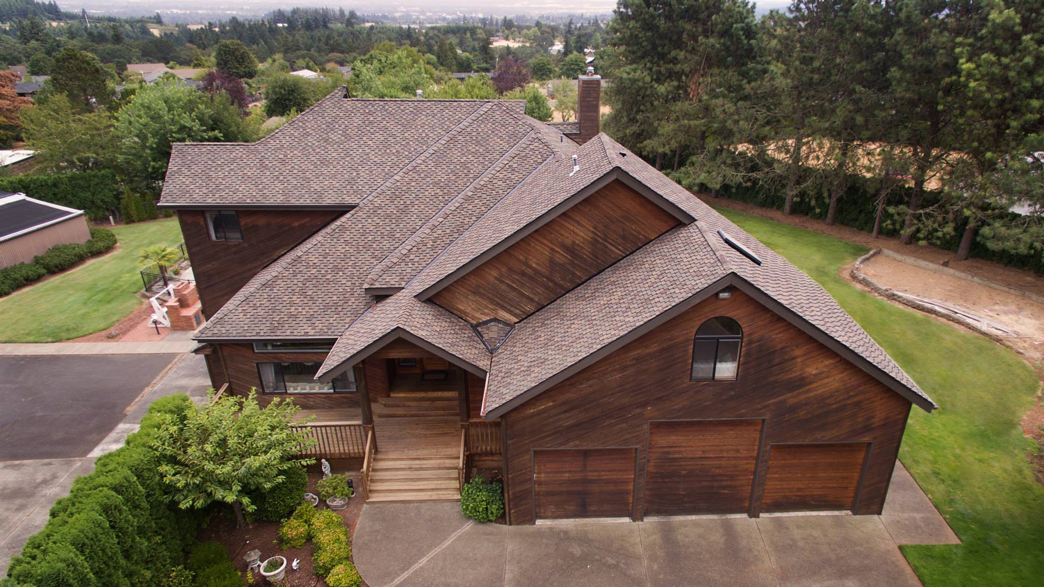 Valley Roofing did this roof, shingles, skylights, and gutters on a unque wooden home.